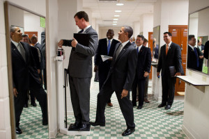 President Barack Obama puts his toe on the scale as Trip Director Marvin Nicholson tries to weigh himself during a hold in the volleyball locker room at the University of Texas in Austin, Texas, Aug. 9, 2010. (Official White House Photo by Pete Souza)